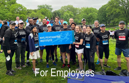 Diverse group of adults in athletic clothing holding a sign that says NYS Psychiatric Institute